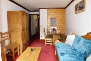 ein Wohnzimmer mit einem Sofa und einem Tisch in der Unterkunft Résidence Alpina Lodge by Valdiski in Val dʼIsère