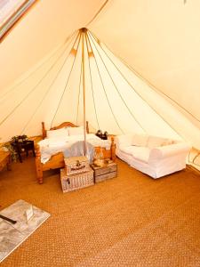 a room with two beds in a tent at Fen meadows glamping - Luxury cabins and Bell tents in Cambridge