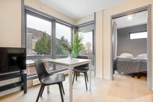 a living room with a table and chairs and a bedroom at Forenom Serviced Apartments Oslo Munch in Oslo