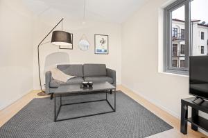 a living room with a couch and a tv at Forenom Serviced Apartments Oslo Munch in Oslo