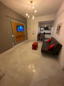 a living room with a couch and a television at 952A golden fortaleza in Fortaleza