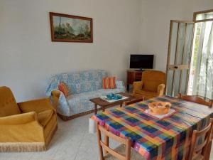 a living room with a couch and a table at Rocca tagliata Marsala in Marsala