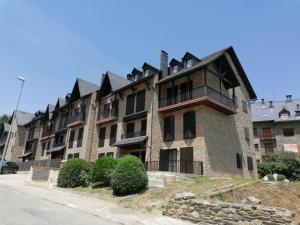 a large building on the side of a street at Dúplex en Valencia d'Àneu (Baqueira Beret) in Valencia de Aneu