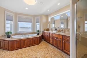 a bathroom with a tub and two sinks and a shower at Harbour View Haven in Stratford +123 photos
