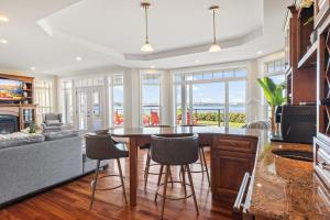 a kitchen and living room with a table and chairs at Harbour View Haven in Stratford