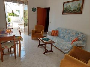 a living room with a couch and a table at Rocca tagliata Marsala in Marsala