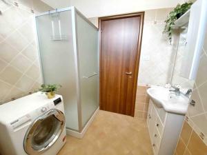 a bathroom with a washing machine and a sink at BELLAVISTA , Bright and Stylish Two Bedroom Apartment in the Historic Center in Ravenna +28 photos