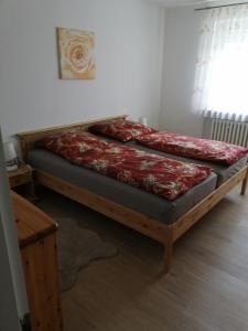 two twin beds in a room with a window at Ruhige Ferienwohnung am Waldrand. in Wildflecken