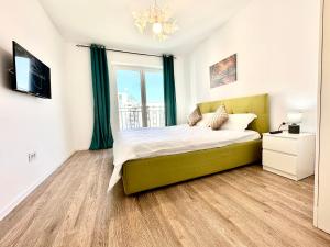 a bedroom with a bed and a large window at Kasper Coresi Mall - Rise Private Apartments & Suites in Braşov
