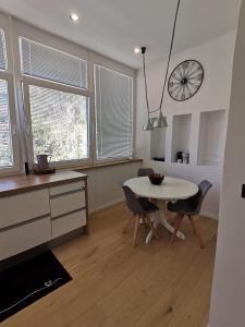 a kitchen and dining room with a table and chairs at KELEIA NEW VILLAGE in Celje +4 photos