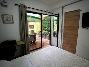 una camera con letto e porta di accesso a un patio di CoLinkHouse Hotel a Medellín