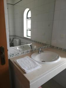 a bathroom with a sink and a mirror at Villa V2 V in Olhos de Água +35 photos