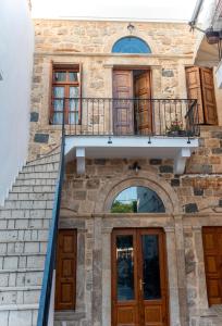 a building with a staircase and a balcony at Lithos apartments in Kalymnos
