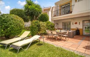 een patio met stoelen en een tafel in de tuin bij Stunning Home In Estepona With Kitchen 