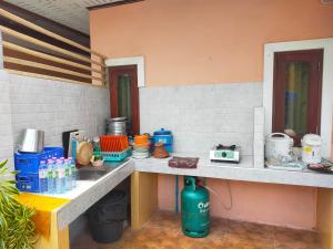 a kitchen with a counter with food and drinks on it at เดอะเบสท์ พูลวิลล่า ขนอม in Ban Tha Chan