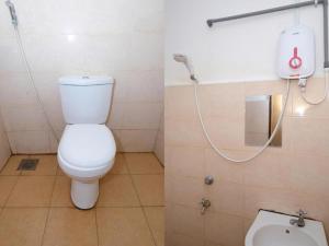 a bathroom with a white toilet and a shower at De'Light Villa 