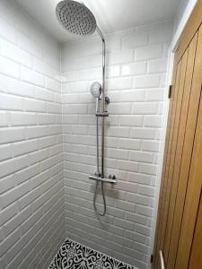 a bathroom with a shower with a shower head at 310, The Kové, West Hill Road in Bournemouth
