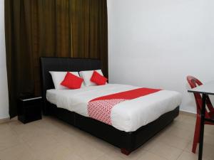 a bedroom with a large bed with red pillows at De'Light Villa 