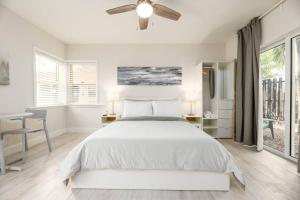 a white bedroom with a bed and a desk at Ocean Flats 3 - Lauderdale-by-the-Sea in Fort Lauderdale