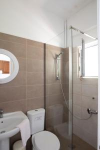 a bathroom with a toilet and a sink and a shower at Bay Apartments - Kalami by Sunvil in Kalami