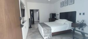 a bedroom with a white bed and a glass table at La Casa Mia Leon in León