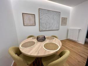 a dining room with a wooden table and chairs at Redi Home in Bari
