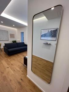a mirror on a wall in a living room at Redi Home in Bari
