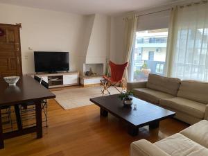 a living room with a couch and a table at Modern Flat in Nafplio in Nafplio