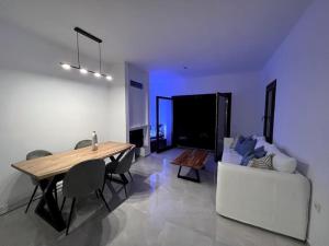 a living room with a table and a white couch at The Yacht House in Agios Ioannis Pelio
