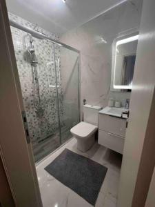 a bathroom with a shower and a toilet and a sink at The Yacht House in Agios Ioannis Pelio +33 photos