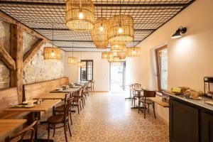 a row of tables in a restaurant with chandeliers at La Ferme du Lignon in Geneva