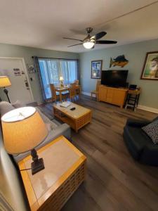 a living room with a couch and a table at The Floranada Condo at Pompano Beach 9 in Pompano Beach