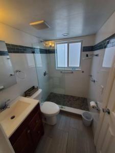 a bathroom with a toilet and a shower and a sink at The Floranada Condo at Pompano Beach 9 in Pompano Beach