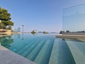 a swimming pool in the middle of a house at Villa Ftelia Oasis,Skiathos in Megali Ammos