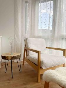 1 dormitorio con cama, mesa y ventana en Appartement calme et lumineux de 2,5 pces proche Lausanne, en Ecublens