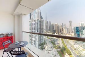 a balcony with a table and chairs and a city at West Heights 2 - Vacationer in Dubai