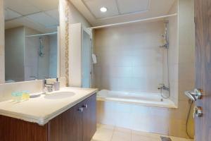 a bathroom with a sink and a bath tub at West Heights 2 - Vacationer in Dubai