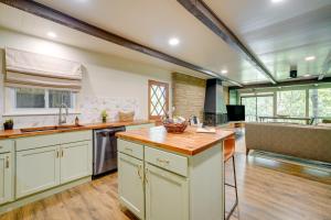 a kitchen with white cabinets and a wooden counter top at Idyllic Eufaula Vacation Rental Close to Lake! in Eufaula
