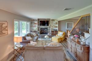 a living room with couches and a fireplace at Lakefront Gloversville Getaway with Beach and Dock! in Broadalbin