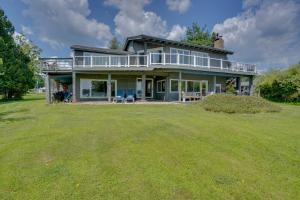 a large house with a large yard at Lakefront Gloversville Getaway with Beach and Dock! in Broadalbin