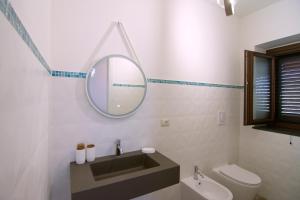 a bathroom with a sink and a mirror at Villa Rosa Francesca in Acciaroli +10 photos