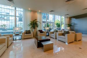 a lobby with couches and tables in a building at Olissippo Oriente in Lisbon