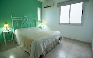 a bedroom with a large bed and a window at Hacienda Don Justo Hotel Boutique Spa in Colón