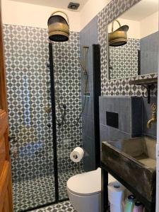 a bathroom with a shower and a toilet and a sink at Central, Authentic and Stylish Old Yafo Experience in Tel Aviv