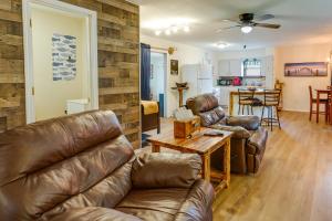 a living room with leather furniture and a table at Quaint Warsaw Getaway with Covered Porch and Kayaks! in Warsaw