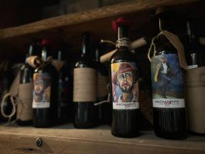 a group of bottles of wine on a shelf at Machanents Art Hotel in Vagharshapat