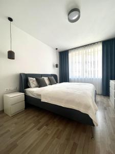 a bedroom with a large bed and a large window at MT SUITES BUDAPEST in Budapest