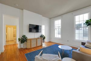 a living room with a couch and a tv at Guthrie Coke Lofts, Walkable Entertainment in Louisville