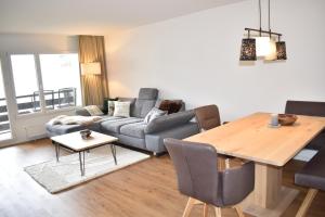 a living room with a couch and a table at Rhodania A 3003 Kl in Lenzerheide