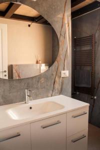 a bathroom with a sink and a mirror at poppy loft in Grottaferrata